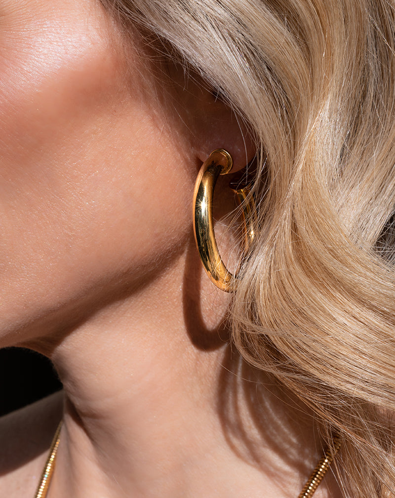 Close-up of woman wearing Medium Hoop Earring in gold