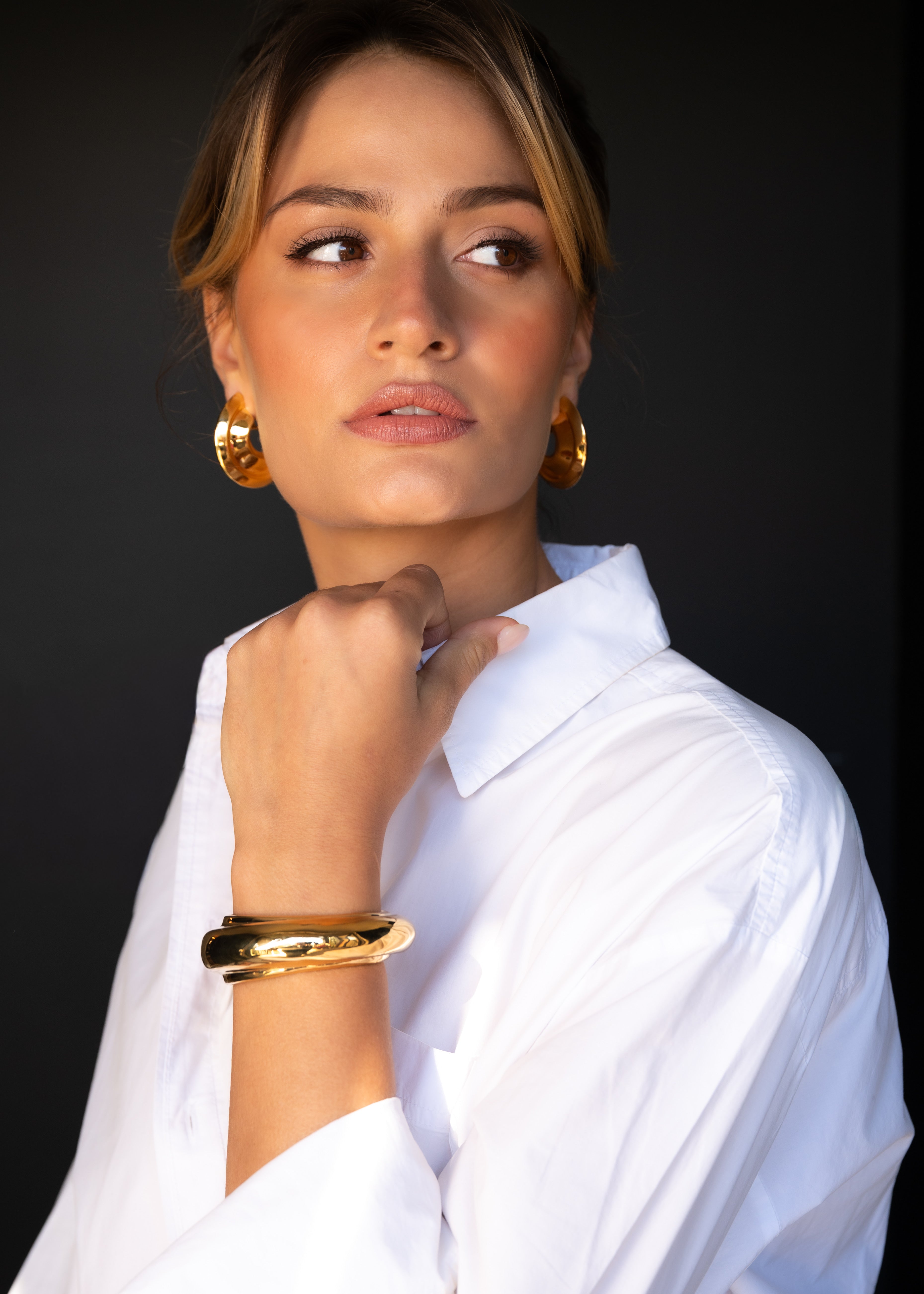 Woman wearing gold hoop earring