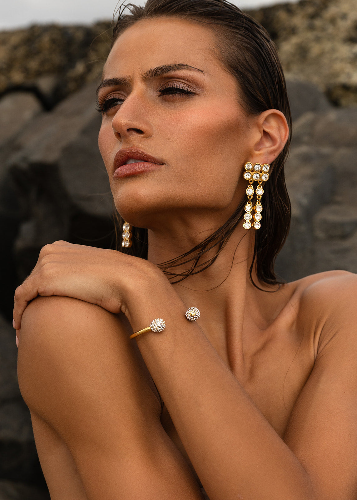 Woman wearing Bezel Set Dangle Earring with Pave Ball Cuff