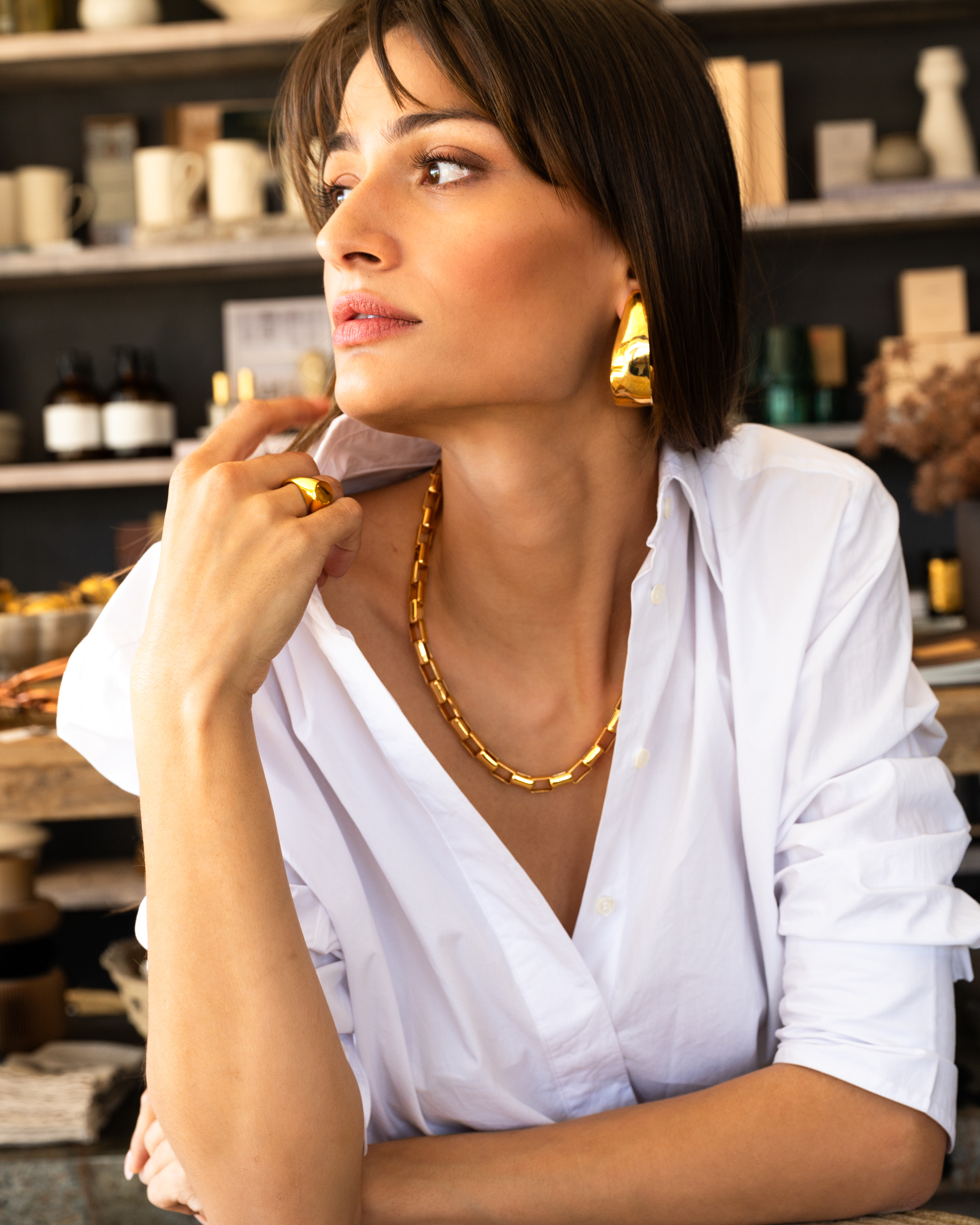 Woman wearing Box Link Necklace in gold and Petal earrings