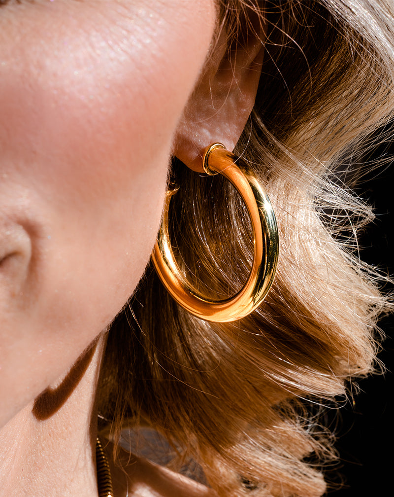 Close-up of woman wearing Medium Hoop Earring