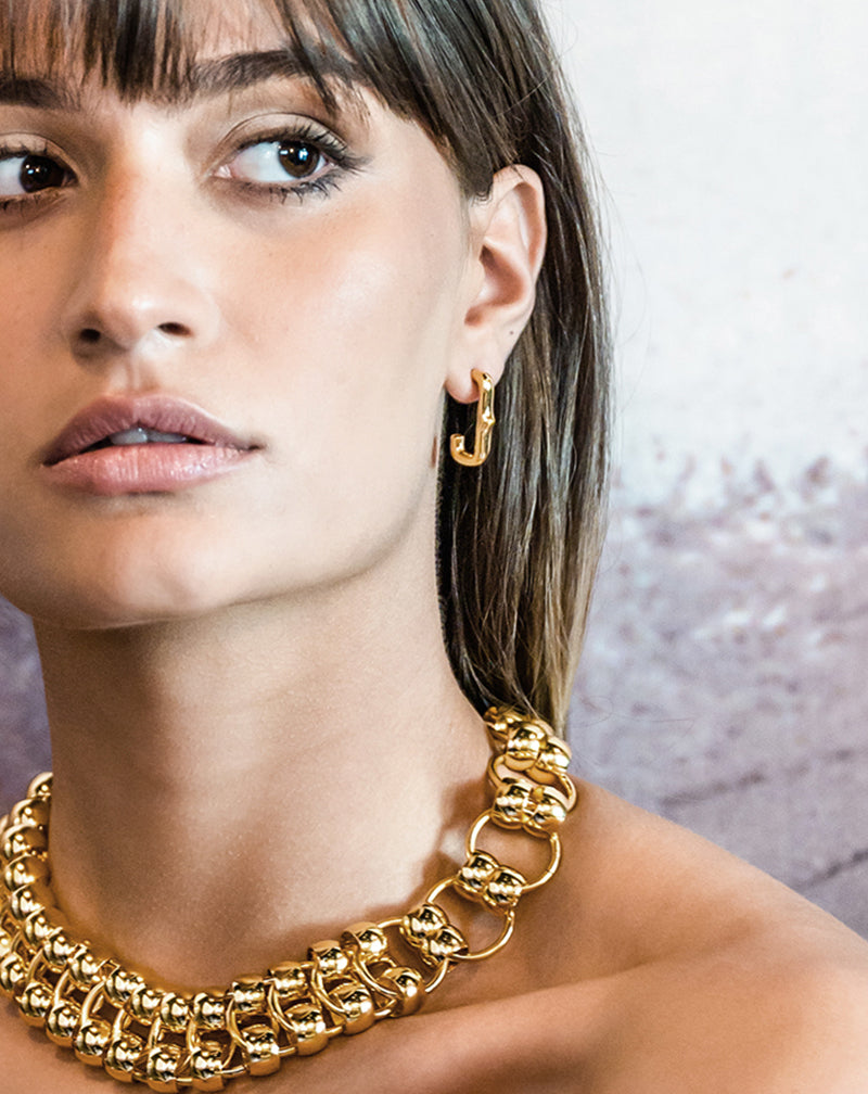 Brunette woman wearing Heritage Huggie Earring
